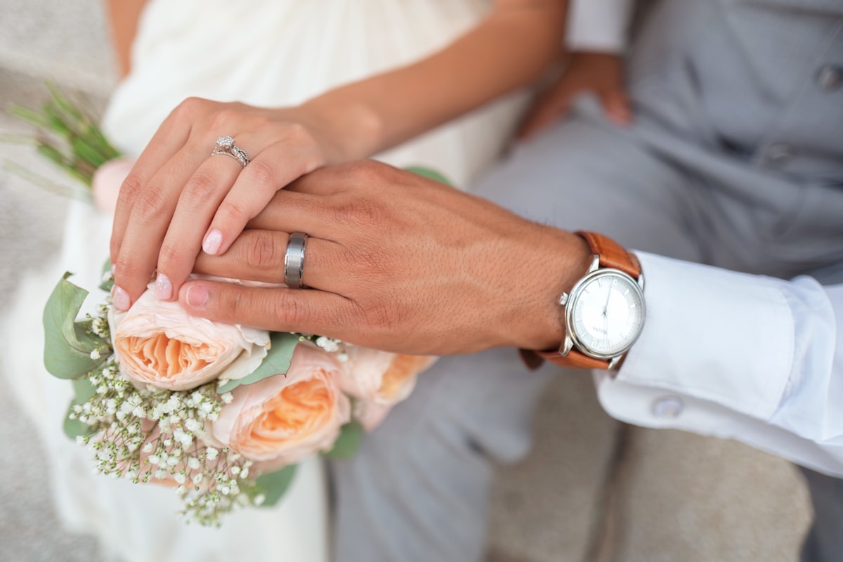 Candid wedding ceremony moment — guests watching the couple exchange vows